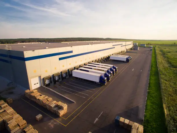 distribution warehouse with trucks of different capacity.